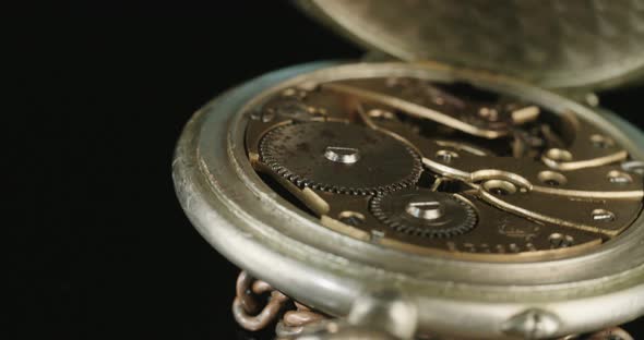 Macro shot of an antique pocket watch on a dark background