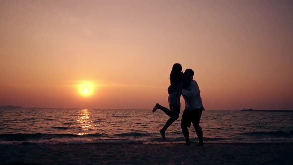 Girl Runs To Guy and Couple Turns on Beach Slow Motion