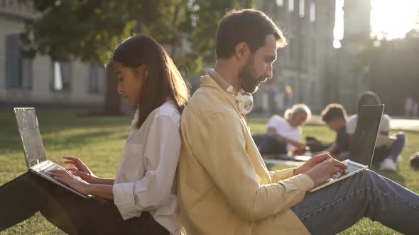 Young Woman and Man Students During Study Outdoors