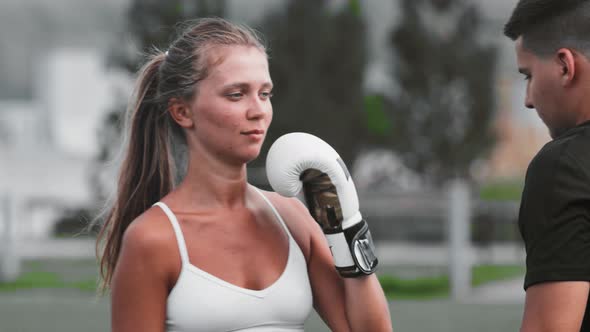 Young Woman in White Top Having a Boxing Training with Her Coach