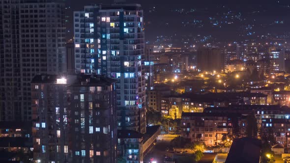 Multistorey Buildings with Changing Window Lighting At Night in City. Timelapse