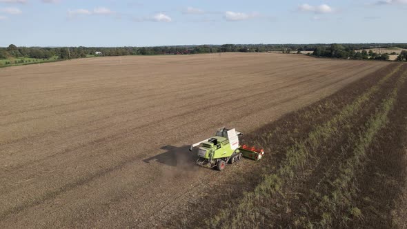 Drone shot of a combine harvester at work in a large Irish field