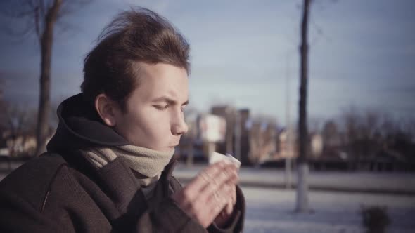 Young Boy Blowing in a Tissue in a Cold Winter