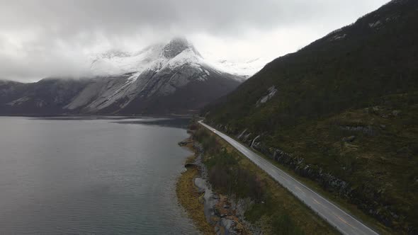 A car drives on a Scandinavian mountain road in winter. Stetind Mountain in Norway