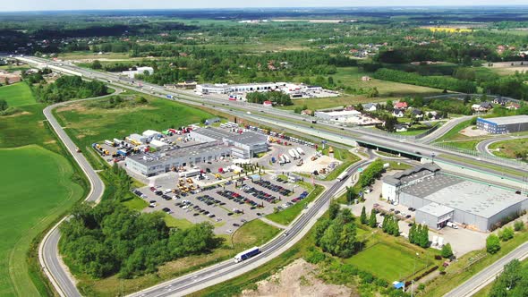 Aerial top down view of the big logistics park with warehouses, loading hub and a lot of semi trucks