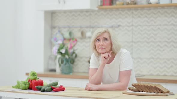 Worried Senior Old Woman Thinking While Standing in Kitchen