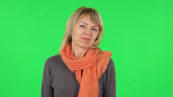 Portrait of Middle Aged Blonde Woman Is Showing Disgust . Green Screen