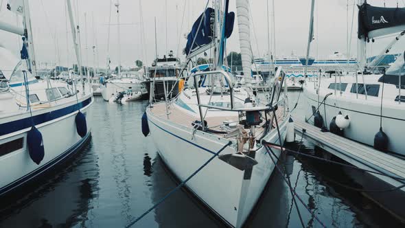 Blue Sailboat Moored to a Pier in Yacht Marina at Sunset