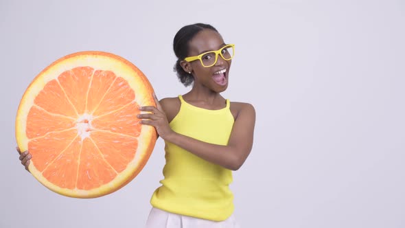 Young Happy African Woman Holding Orange Pillow As Healthy Concept