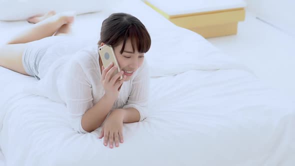 Young asian woman using smart phone talking enjoy and fun.