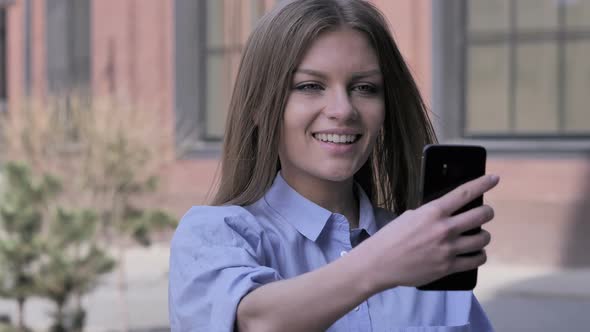 Woman Outside Office Taking Selfie on Smartphone