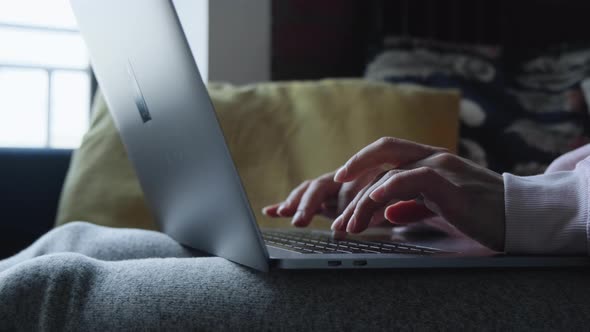 Close-up of female hands typing laptop keyboard. young woman using laptop