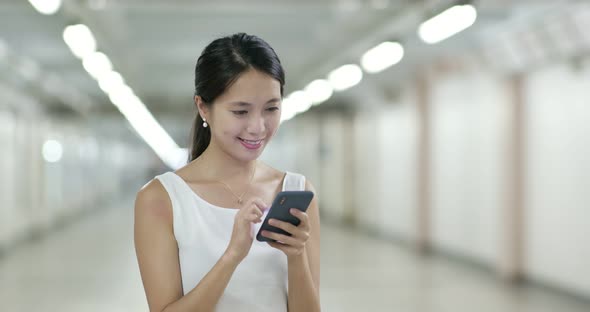 Woman look at mobile phone in city