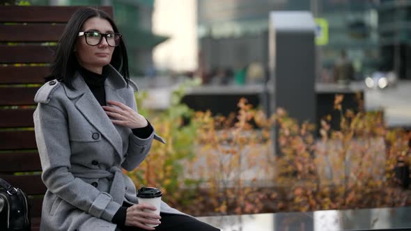 Successful Woman is Resting in Break Time During Working Day Drinking Coffee in City Center