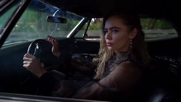 Confident and Arrogant Sexy Woman Is Smoking Inside Her Car, Waiting Someone on Parking