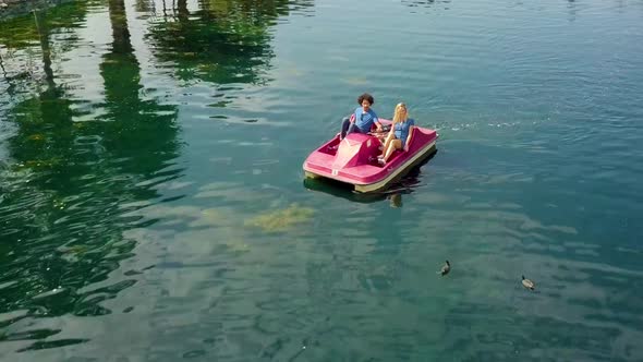 Cute Couple Enjoying A Boat Ride In The Park