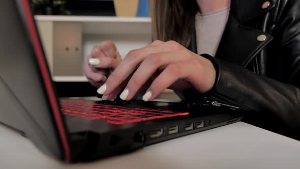 Hands Woman Hacker Hacking Security System on a Powerful Laptop Computer at Home at Night