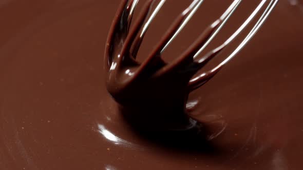 Mixing Stirring Melted Liquid Dark Chocolate with Whisk Confectioner Prepares Dessert Topping