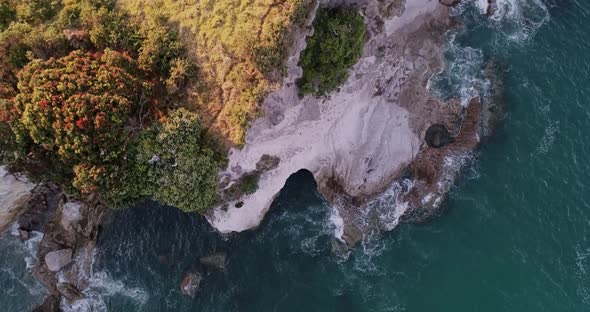 Aerial - Wide angle of Cathedral Cove New Zealand. Looking down on crashing waves