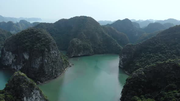 Aerial: flying over Ha Long Bay rock pinnacles, famous tourism destination in Vietnam