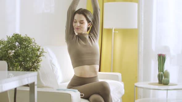 An Attractive Woman is Stretching and Raising Up Her Hands