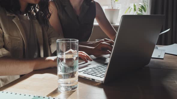 Female Colleagues Working on Laptop Together