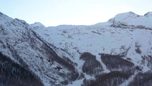 Tilt down of ski lifts in beautiful snow covered mountains