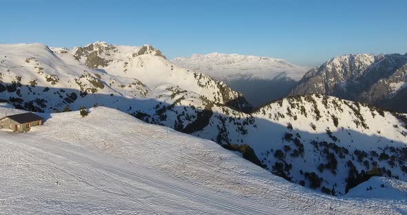 Chamrousse ski resort summit with shelter cabin at the French Alps, Aerial dolly in shot