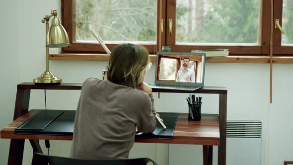 a Woman or Girl in Her House Takes Online Lessons of Playing a Twopart Musical Instrument  Flute