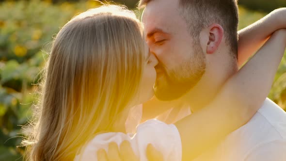 Young Man and Woman in the Sunflower Field