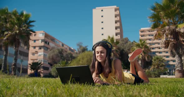 Young Beautiful Freelance Woman Working Outdoors in Park Speaking with Friend