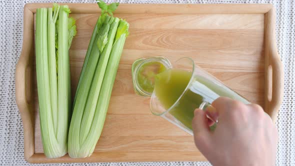 Pouring Green Smoothie In A Jar. Top View.