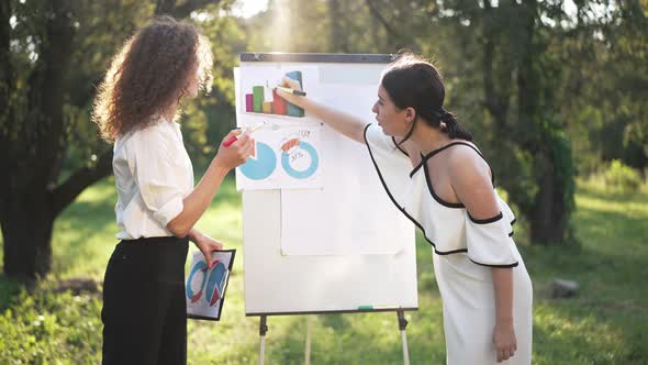 Side View Two Young Women Discussing Business Idea Outdoors Arguing in Slow Motion