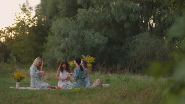 A Group of Young Attractive Women in Nature in the Park Conducts a Master Class on Clay Modeling