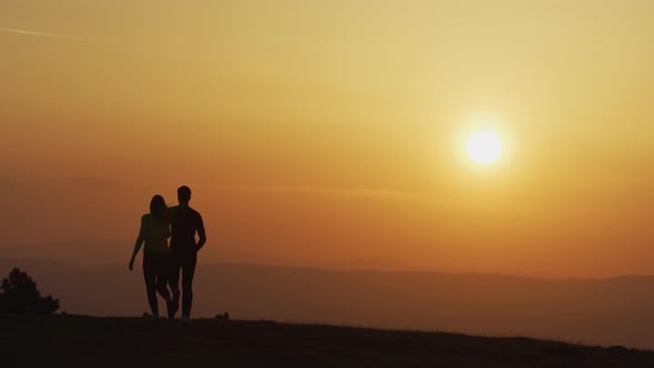 Couple running at sunset