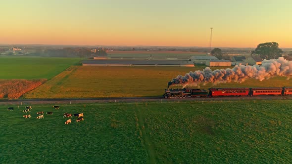 Steam Engine with Passenger Cars at the Golden Sunrise