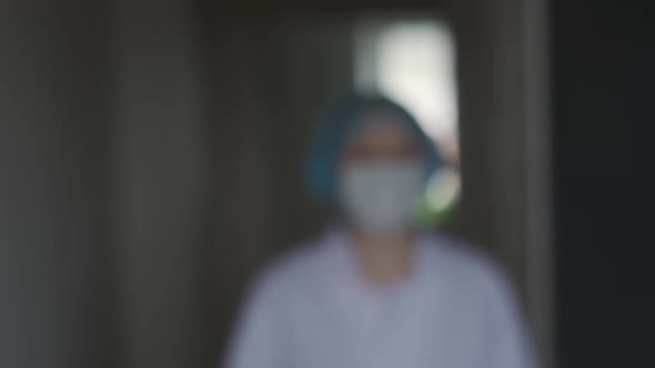 Young Medical Doctor Woman Walking and Looking at Camera