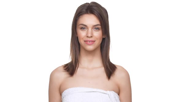 Calm Attractive Caucasian Topless Female Looking at Camera Over White Background in Slowmotion