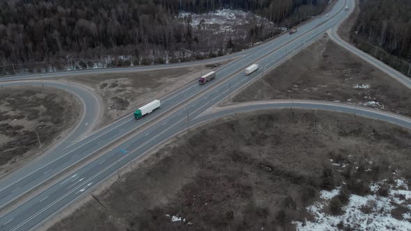 A Car Interchange with an Overpass on a Cloudy Spring Evening in the Woods