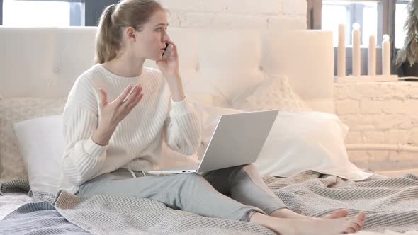 Angry Woman Talking on Phone while Sitting in Bed, Fighting