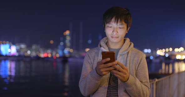 Asian Man Use of Smart Phone at Night