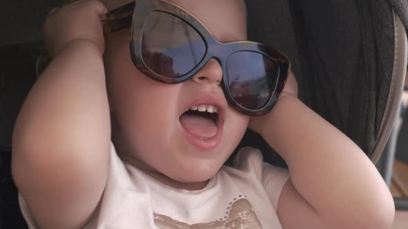 Lovely Baby Girl in Mums Sunglasses