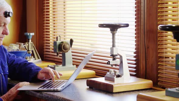 Horologist using laptop