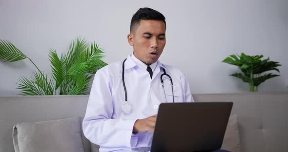 Doctor talking to patient making video call on laptop