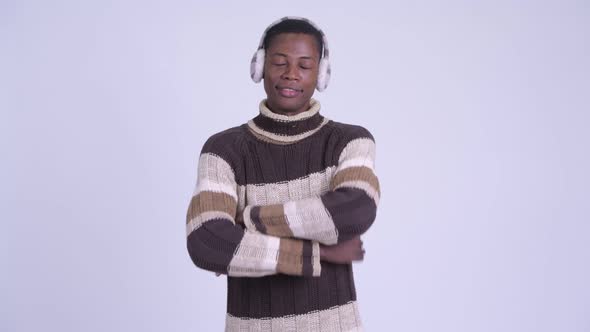 Young Happy African Man Smiling with Arms Crossed Ready for Winter