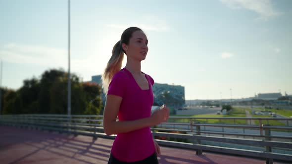 Active Slim Woman Jogging Outside in Sunny Morning