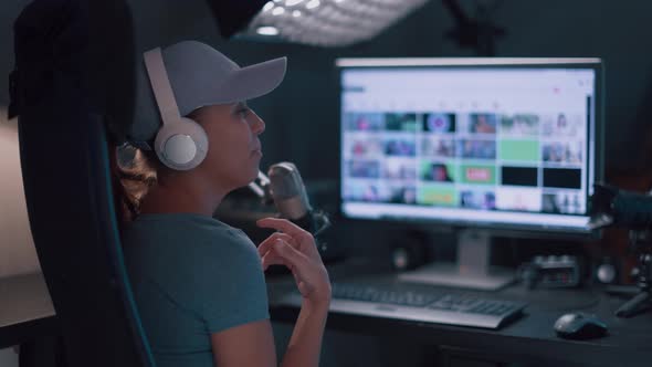 Beautiful Woman In A Cap And White Headphones Leads A Live Stream