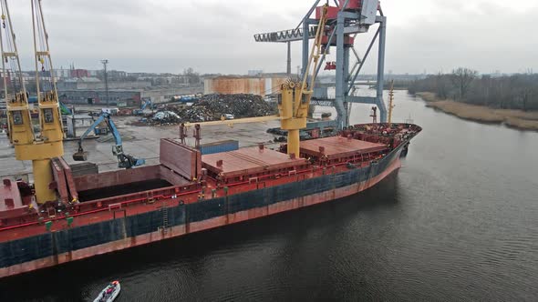 Cargo ship in port with cranes