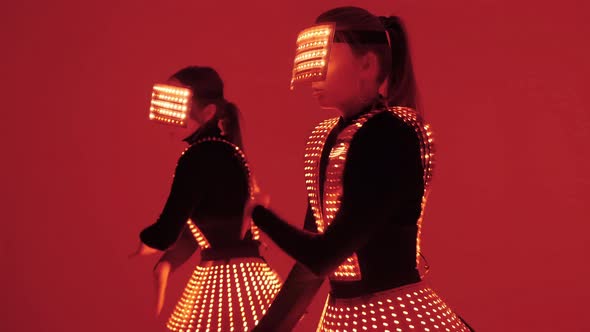Two Disco Dancers Move in UV Costumes