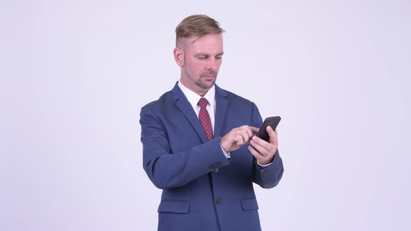 Happy Blonde Businessman Using Phone and Getting Good News